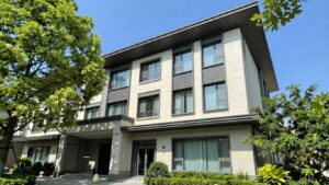 Oaks Embassy Adelaide hotel exterior with trees and blue sky.