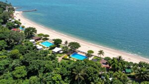 Holiday park by the beach with pools and cabins.