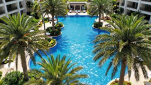 Oaks Pacific Blue Resort pool and surrounding tropical landscape.